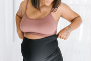 pregnant medium toned woman in black maternity leggings