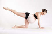 Yoga pose pregnant woman in blush pink support band