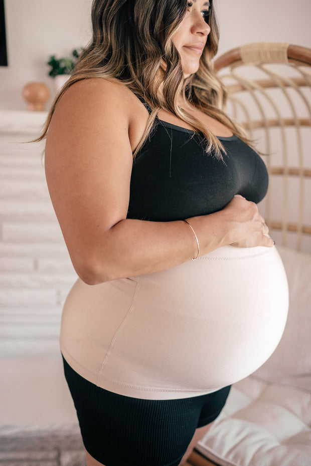 pregnant woman wearing white maternity belly support band